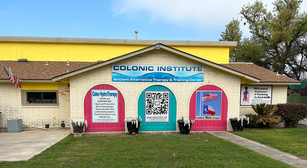 store front of colonic institute with yellow paint and red and teal accents